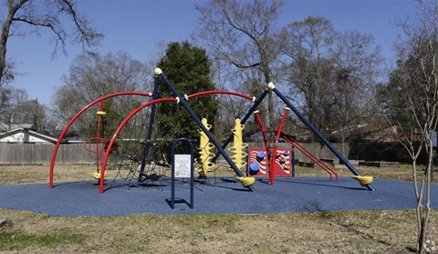 a playground with swings and other toys in a park