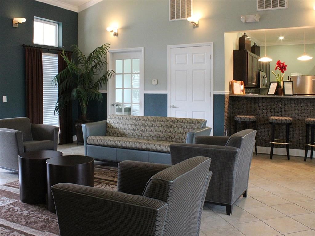 a living room with couches chairs and a bar