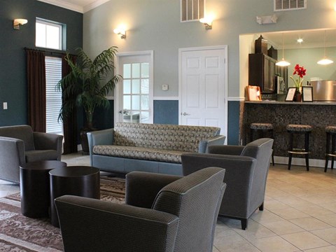 a living room with couches chairs and a bar