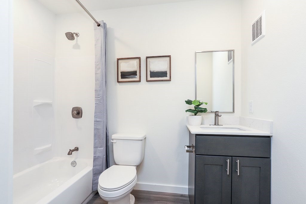 A white toilet sits next to a white sink in a bathroom.