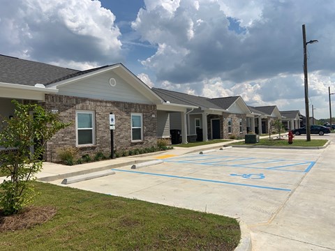 A parking lot in front of a building with a fire hydrant on the right.