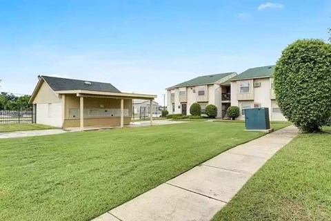 A row of houses with a green lawn in front.