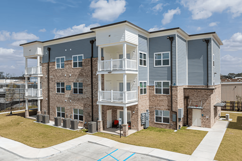 Apartment complex with a mix of brick and siding exteriors.