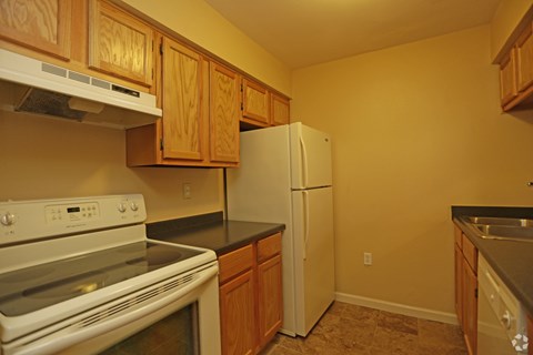 A kitchen with a stove, oven, and refrigerator.