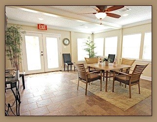 A dining room with a table and chairs.