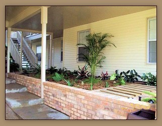 A house with a staircase and a wall of plants.