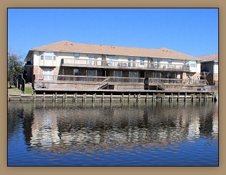 A building is situated on a dock over water.