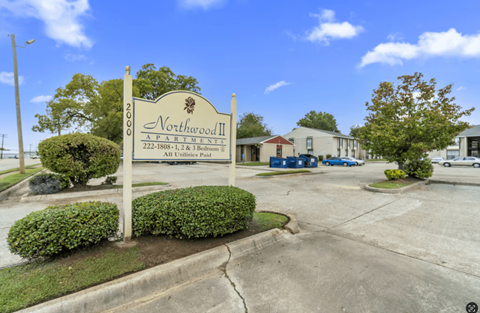 A sign for Northwood II, a 222-bedroom property, stands in front of a building.