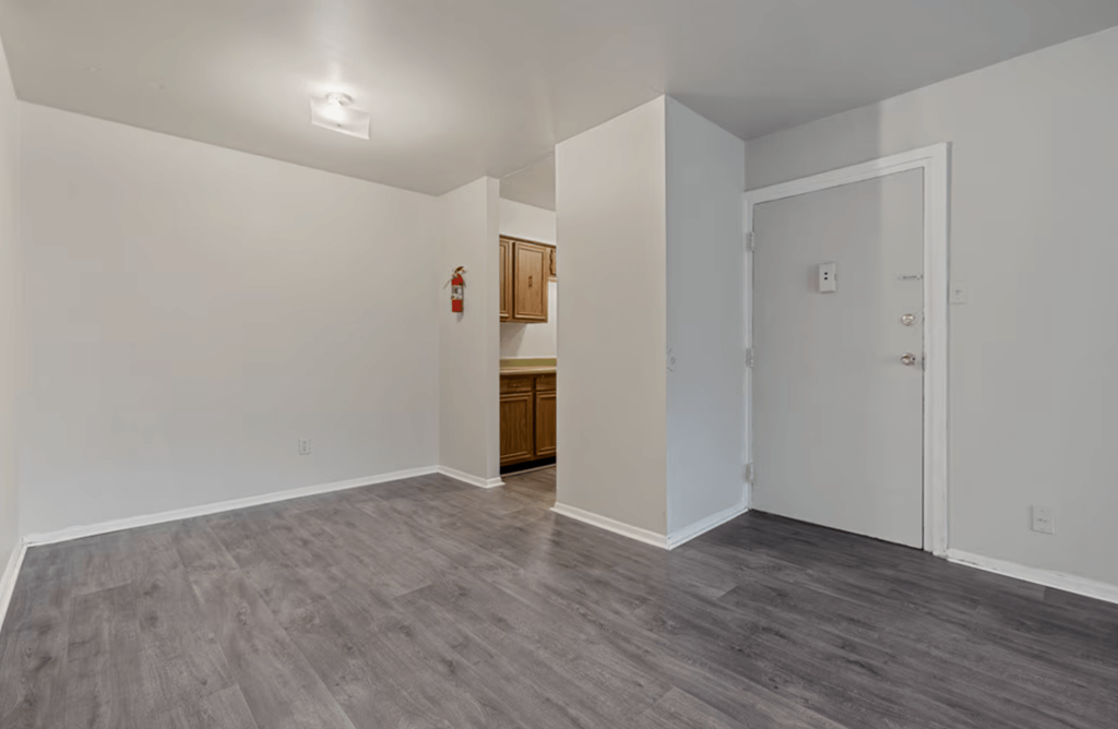A room with a grey floor and white walls.