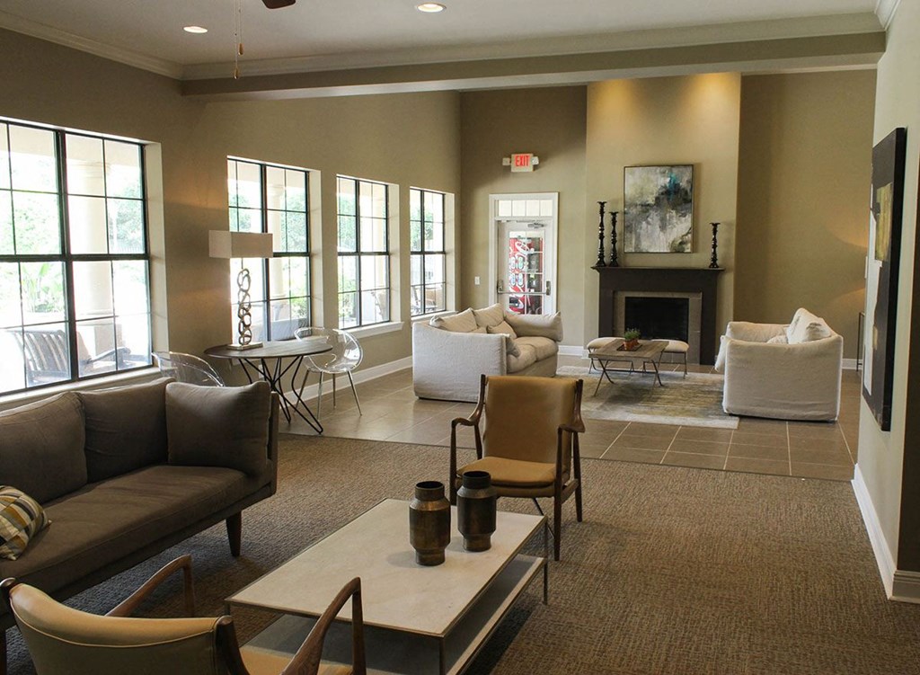 a living room with couches and chairs and a fireplace