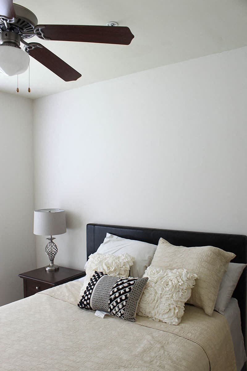 a bedroom with a bed and a ceiling fan
