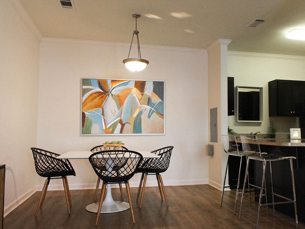 a dining room with a table and chairs