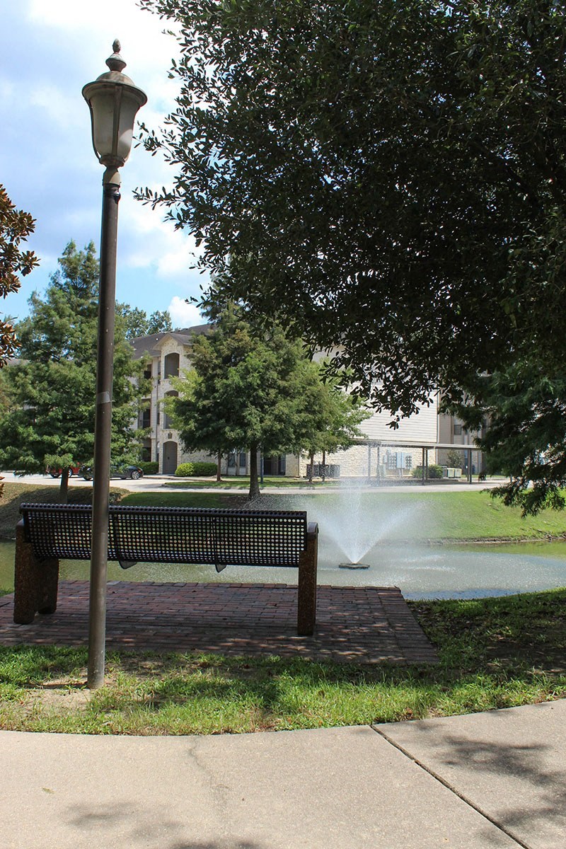 a park bench sitting next to a fountain