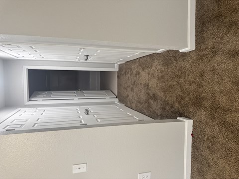 A white refrigerator with a freezer drawer and a water dispenser.