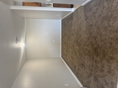 A room with a white wall and a brown wall.