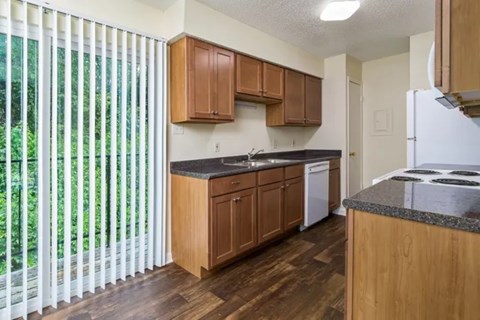 A kitchen with wooden cabinets and a white refrigerator.