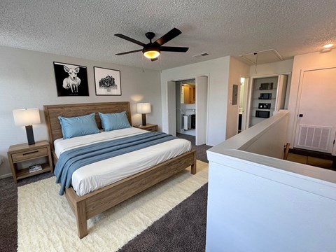 a bedroom with a bed and a ceiling fan