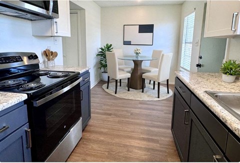 a kitchen and dining room with a table and chairs