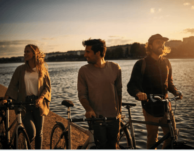 a group of people standing next to a body of water