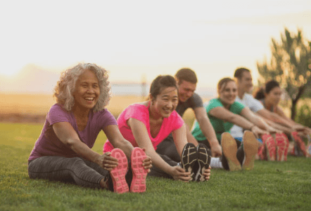 a group of people sitting on the grass