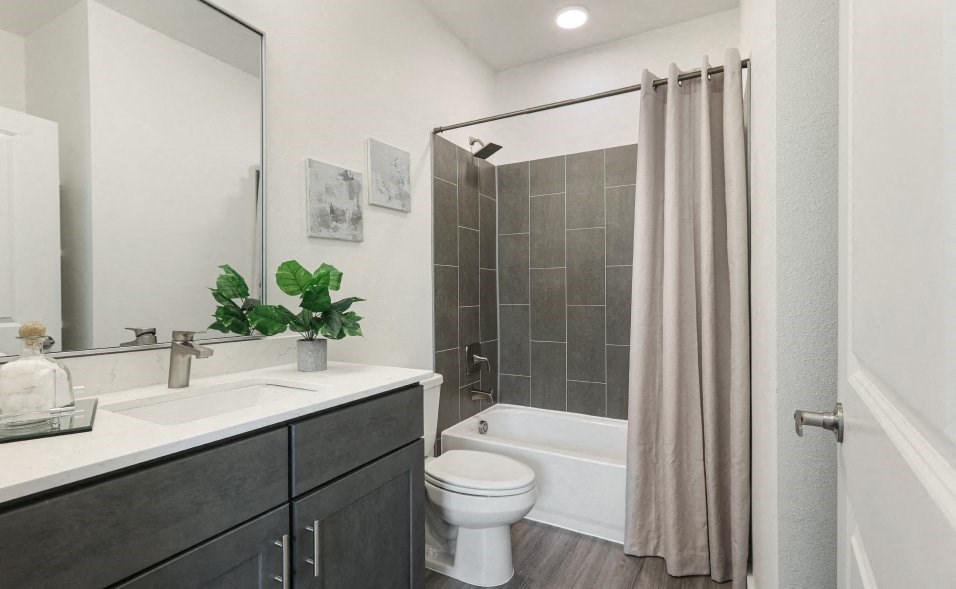 A bathroom with a white toilet and a white sink.