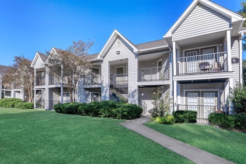 A row of townhouses with a clear blue sky above.