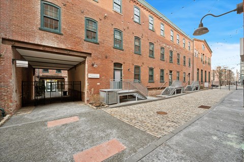 A brick building with a covered walkway in front.