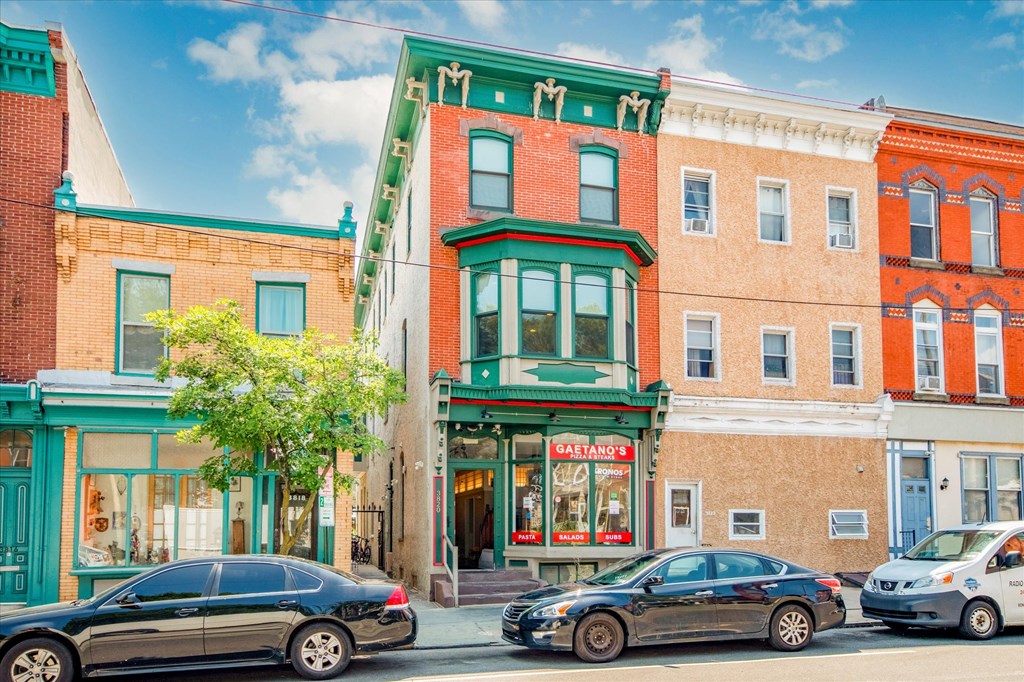 a city street with cars parked in front of a building