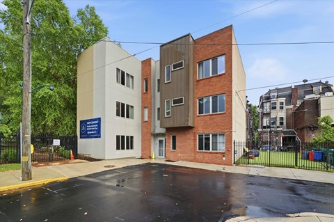 A modern building with a blue sign in front of it.