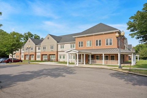 A large building with a parking lot in front at Roosevelt Commons Apartments, Philadelphia, PA