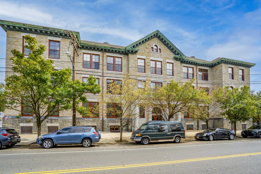 a large brick building with cars parked in front of it