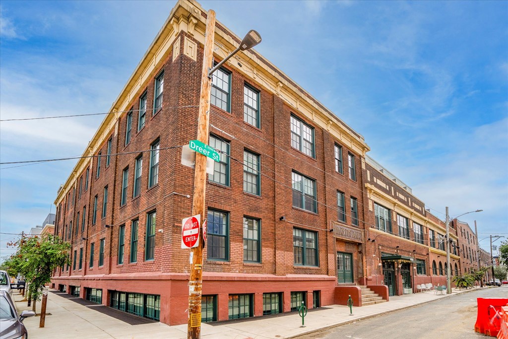 a large brick building with a stop sign in front of it