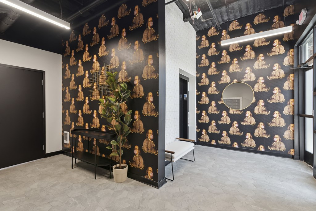 A room with a black and gold wallpaper and a potted plant.