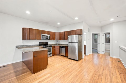 A kitchen with wooden cabinets and stainless steel appliances.