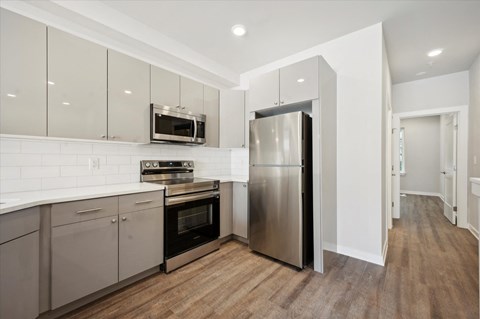 a kitchen with stainless steel appliances and white cabinets