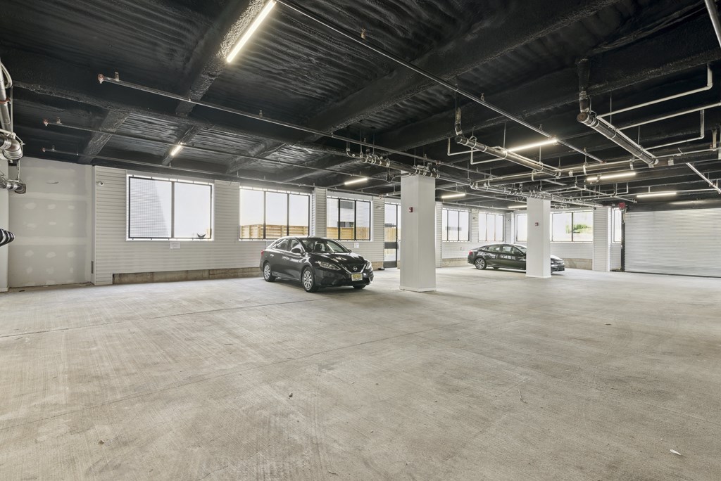 A spacious garage with two cars parked inside.