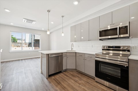 a kitchen with stainless steel appliances and white cabinets