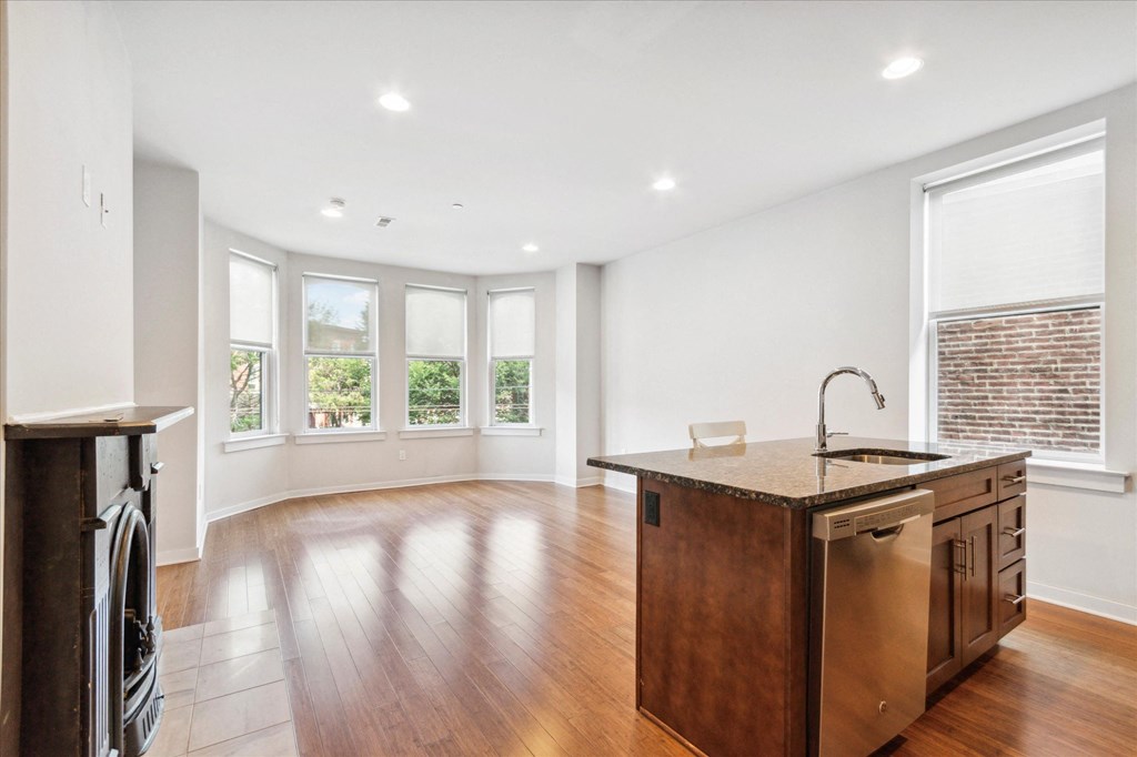 an empty kitchen with an island in the middle of it