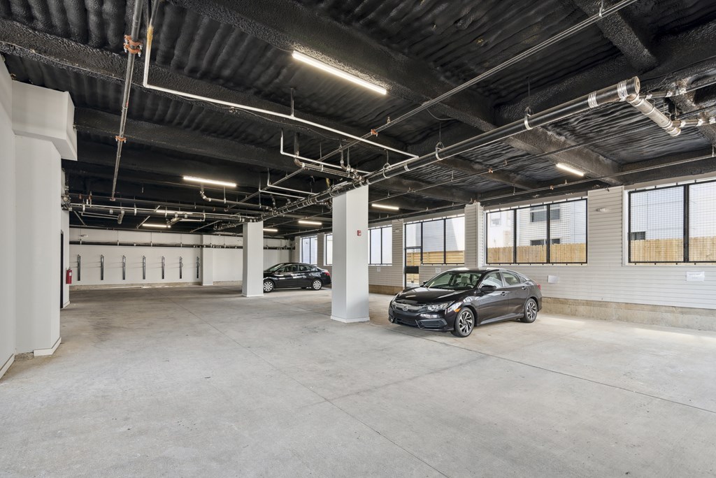 A car is parked in a large, empty garage.
