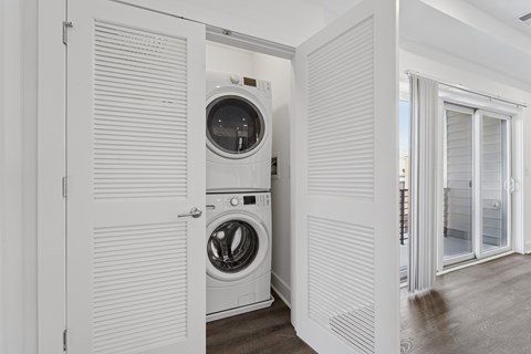 A white laundry room with a washer and dryer.