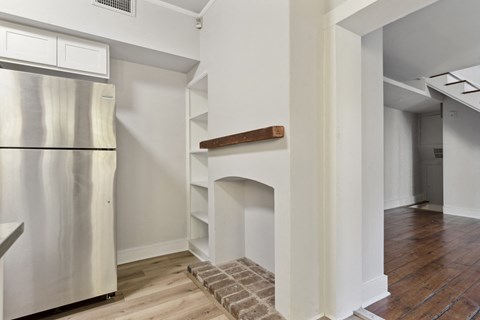 a kitchen with a fireplace and a refrigerator