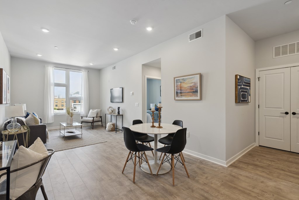 A dining room with a table set for four.