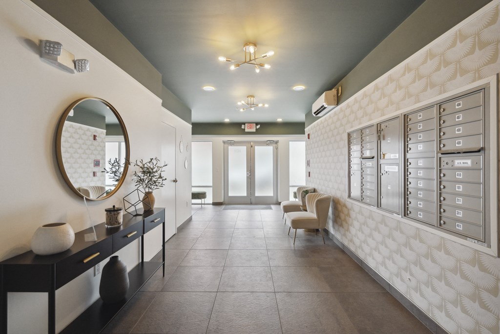 a long hallway with chairs and a mirror in a nail salon