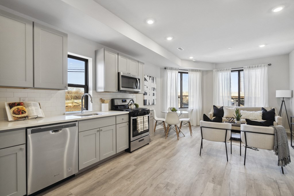 a kitchen and living room with a table and chairs