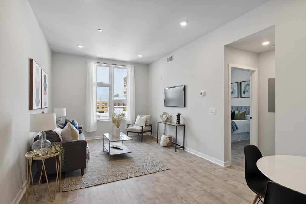 A living room with a couch, chairs, and a coffee table.