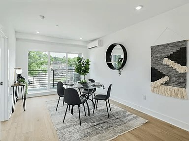 A dining room with a table and chairs.