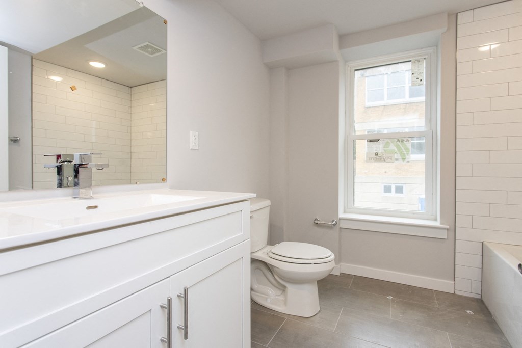a bathroom with a toilet sink and tub