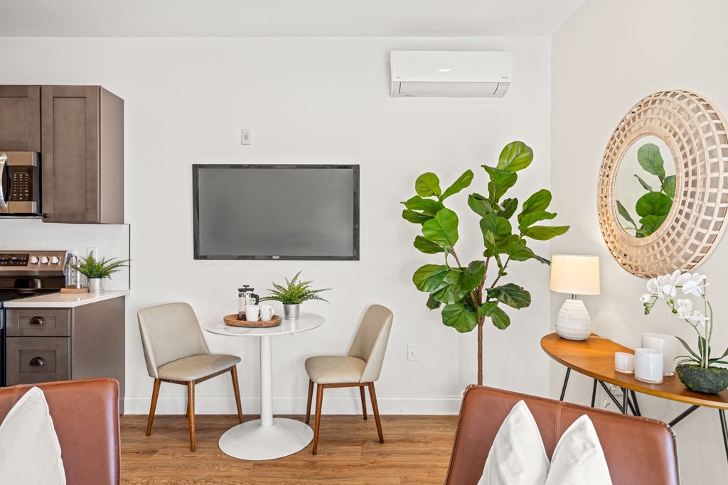 a living room with a table and chairs and a television