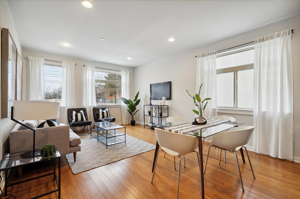 a living room with a couch and a table and chairs