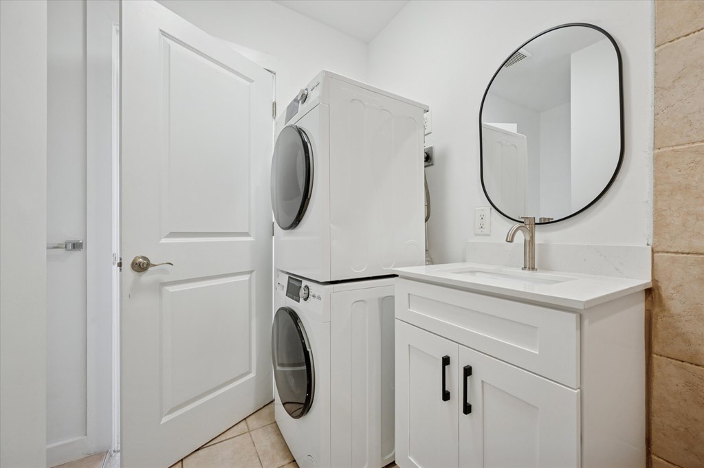 A white laundry room with a washer and dryer.